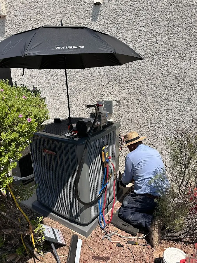 HVAC technician performing outdoor AC maintenance in West Manheim