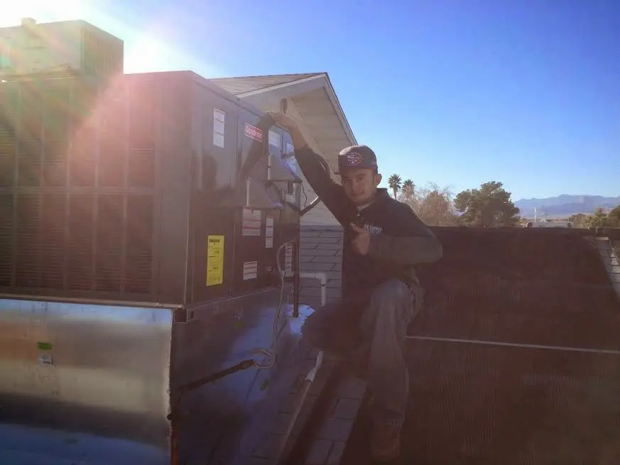 HVAC technician performing HVAC Inspection on a rooftop unit in West Manheim